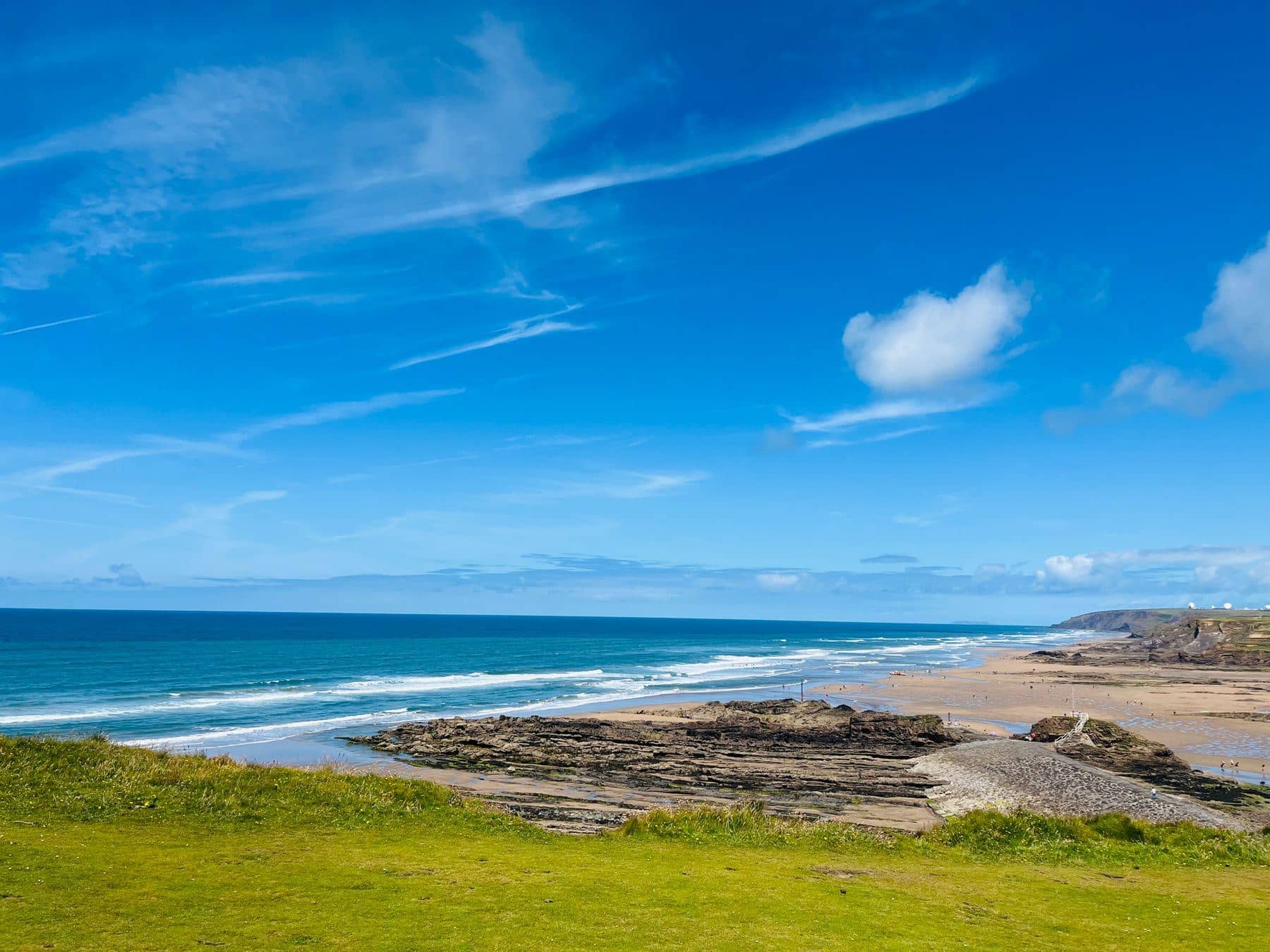 Wide sandy beach and shale ledges on the north Cornwall coast under a blue sky Wide sandy beach and shale ledges on the north Cornwall coast under a blue sky